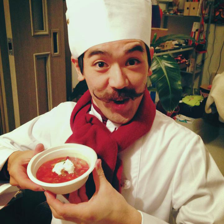 chef with mustache in hat with bowl of chef boyardee