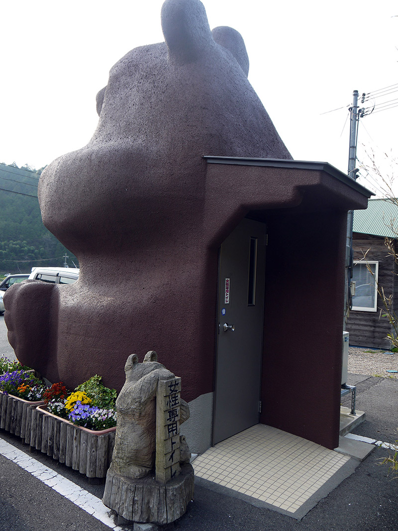bear bathroom bear statue with a door in the back
