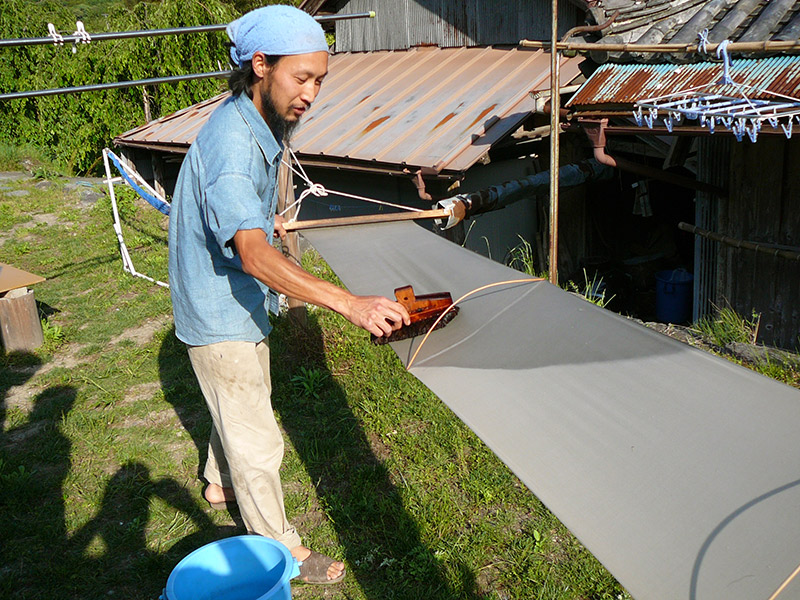 japanese man brushing blue cloth tenugui