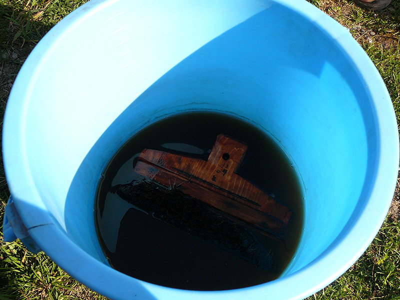 blue bucket of purple dye