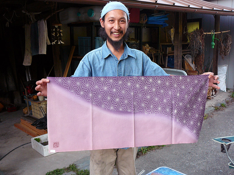 man holding handmade tenugui handdrawn japanese craft