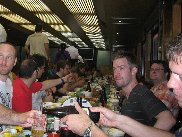 brian ashcraft sitting at long table with friends