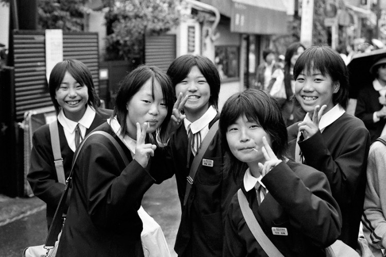 five japanese schoolgirls posing for the camera