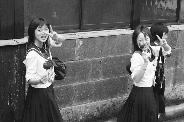 black and white photo of japanese schoolgirls on a walk