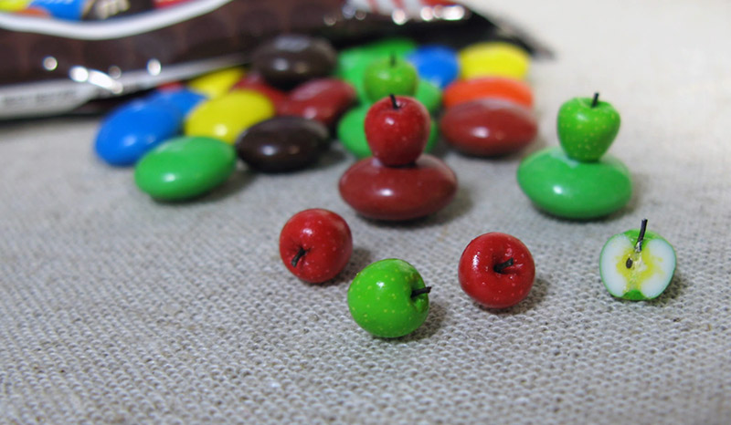 Miniature apples on top of M&Ms