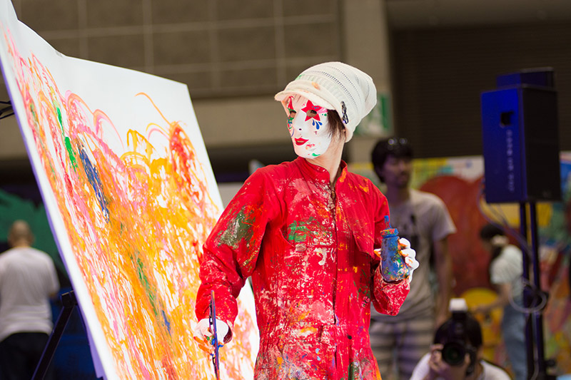 man painting in terrifying mask