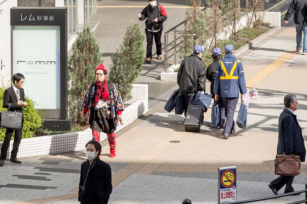 Homeless rental Kotani waiting at the crosswalk in Akihabara Japan