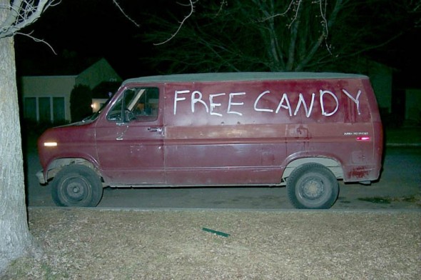 a red van with the words free candy written on the side