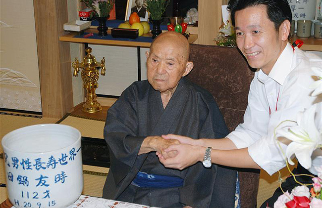 An elderly Japanese man shaking hands