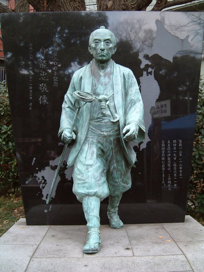 Statue of Ino Tadataka walking forward with a compass in his hand