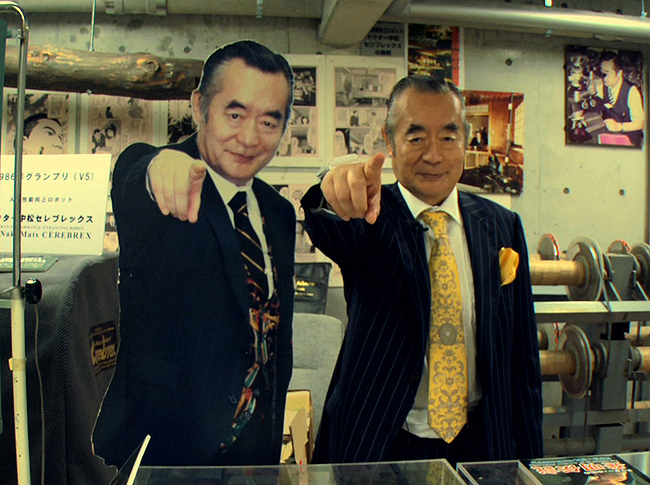 A picutre of Dr. Nakamats pointing at the camera with a cardboard version of him doing the same