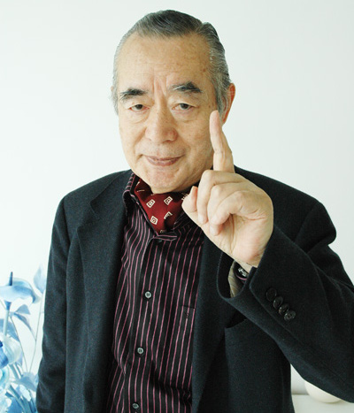 Dr. NakaMats holding one finger up to the camera