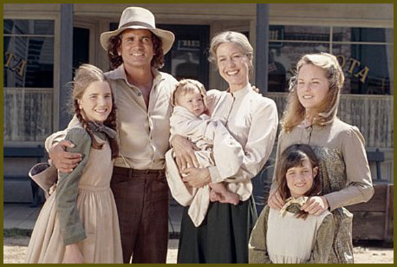 Screenshot from Little House on the Prarie with the main characters standing for a family photo