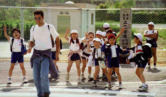 Group of Japanese schoolchildren yelling at a foreigner
