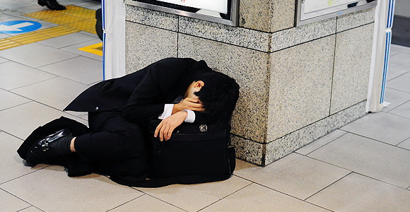 Man in suit collapsed on train station floor