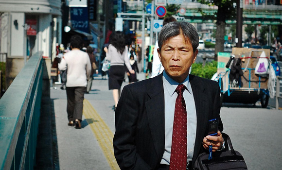 An elderly Japanese businessman on the street