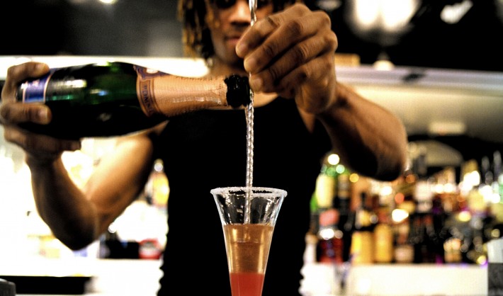 Bartender pouring alcohol into a glass in Japan