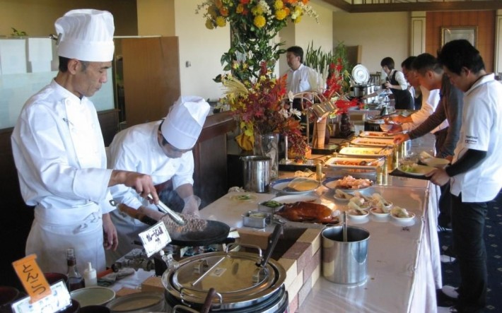 Cooks serving food at a Vikings buffet