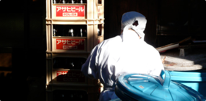 An employee stacking cases of Japanese beer