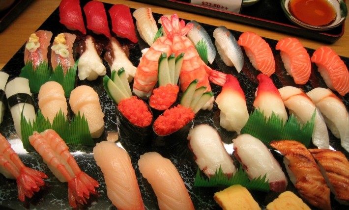 variety of colorful japanese sushi arranged on tray