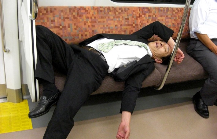 salaryman in suit asleep on train after too much sake