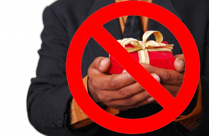 Man holding a gift with a no symbol overlaid