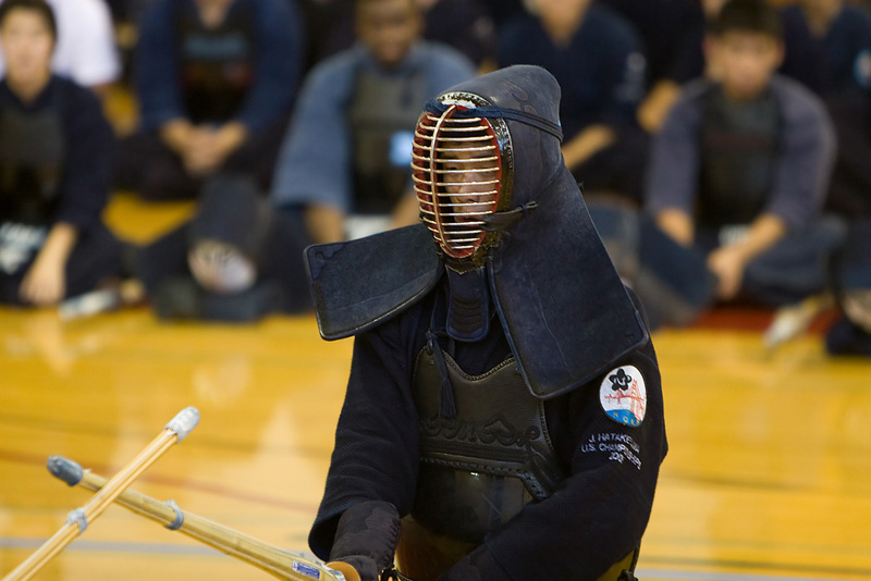 single kendo player in front of a crowd watching