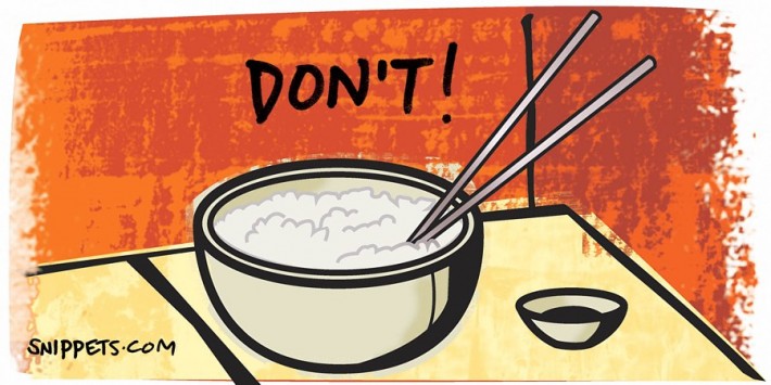 Chopsticks stuck into a bowl of rice with ‘Do not!’ text overlaid