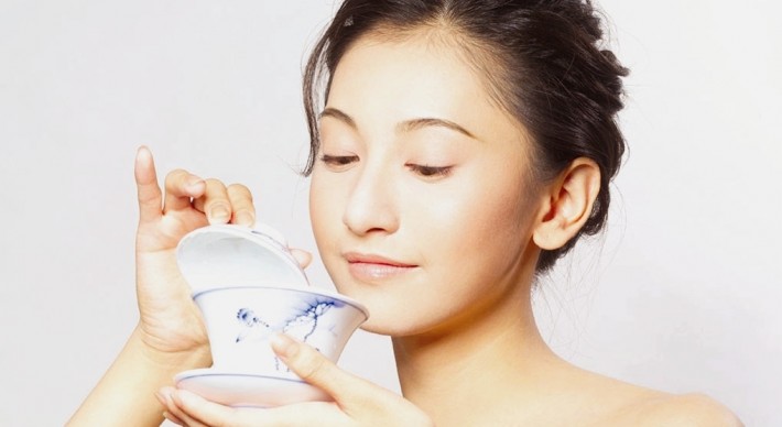 Asian woman holding a tea cup