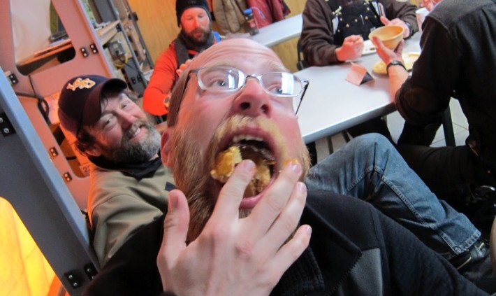 Caucasian man stuffing something into his mouth