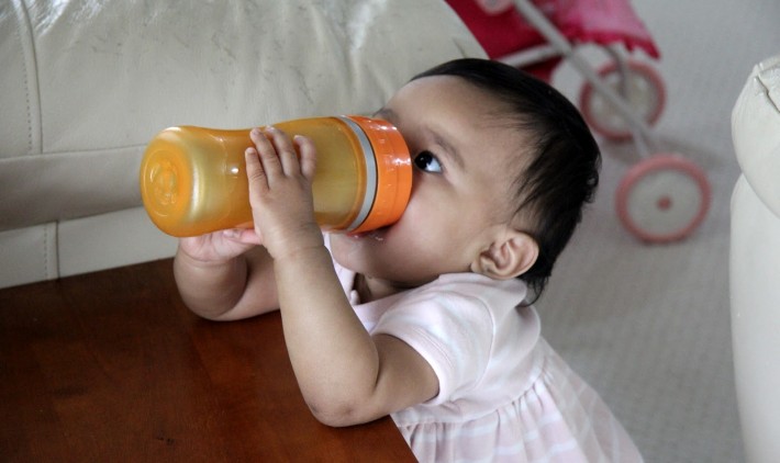 Baby drinking from a sippy cup