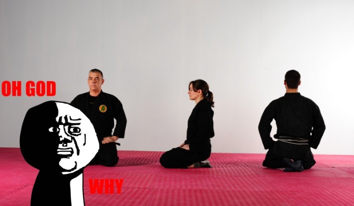 Martial artists sitting seiza with ‘Oh God Why’ image overlaid