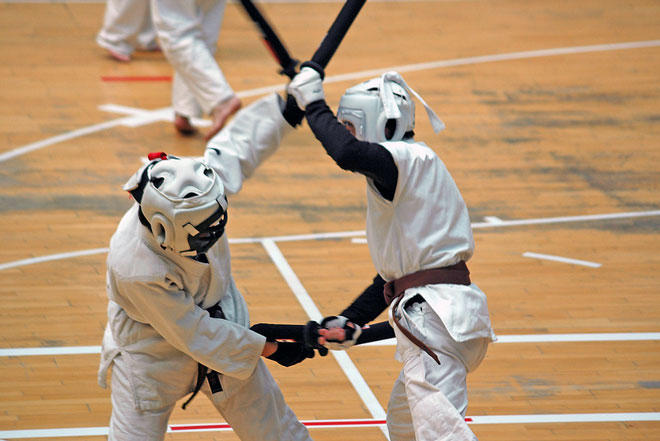 two men fighting with swords in chanbara sport