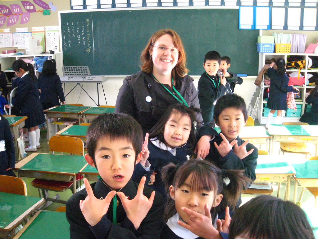 teacher posing with japanese students