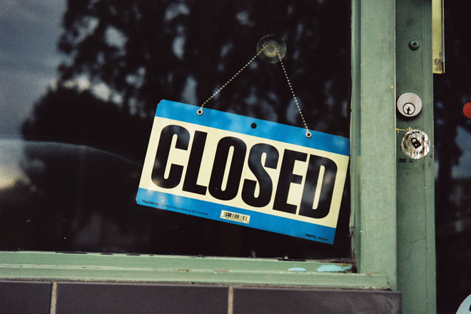 An old wooden door with a closed sign for Thanksgiving