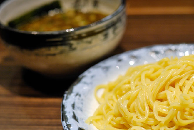 A plate of tsukemen next to a bowl of ramen