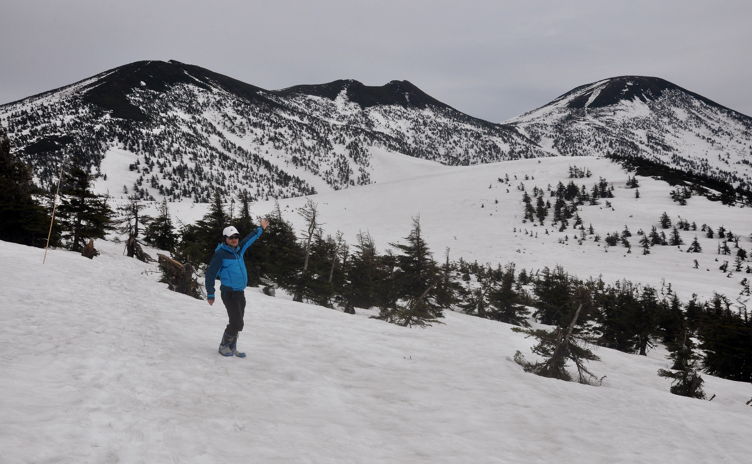 man vaving on mountain in japan