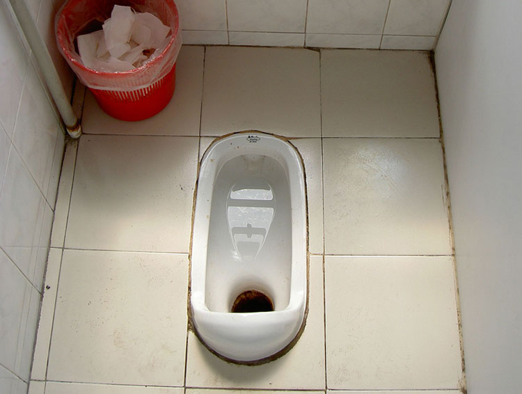 Squat toilet at a Japanese bathroom