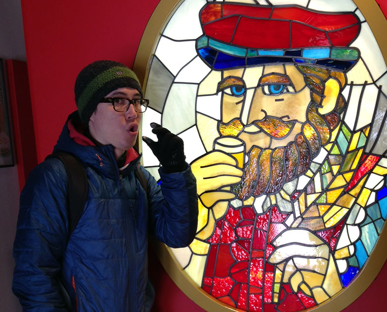 man standing next to stained glass