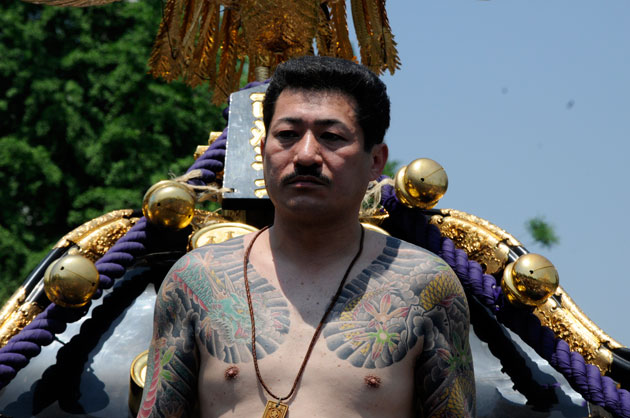 A shirtless Japanese man bearing tattoos