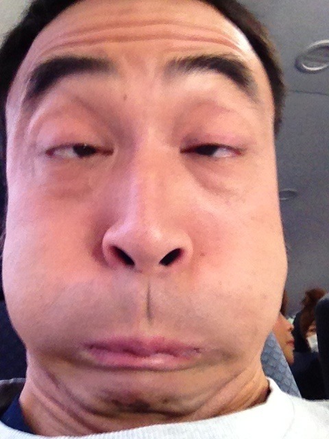 Japanese man makes a weird face while puffing out his cheeks