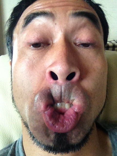 Japanese man makes a weird face while biting his top lip