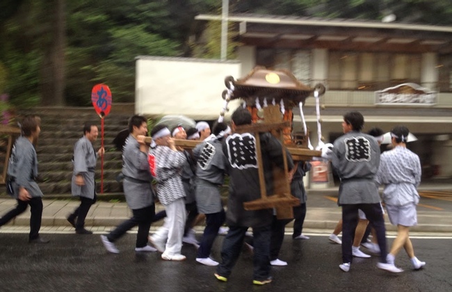 A group of men carry a mikoshi