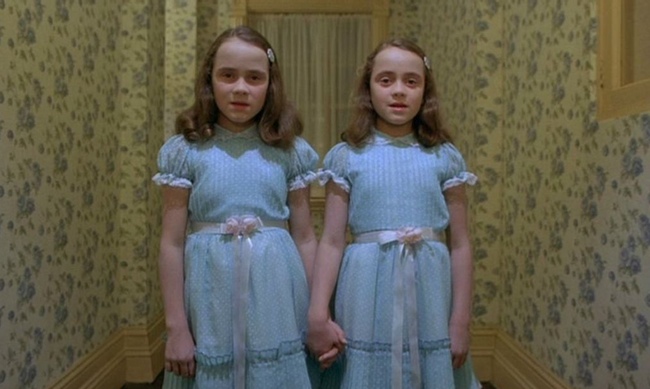 still from the shining two girls standing in a hallway