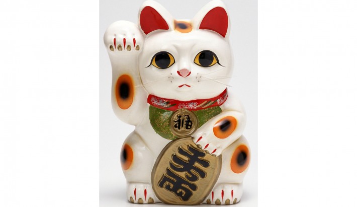 white cat with koban figurine