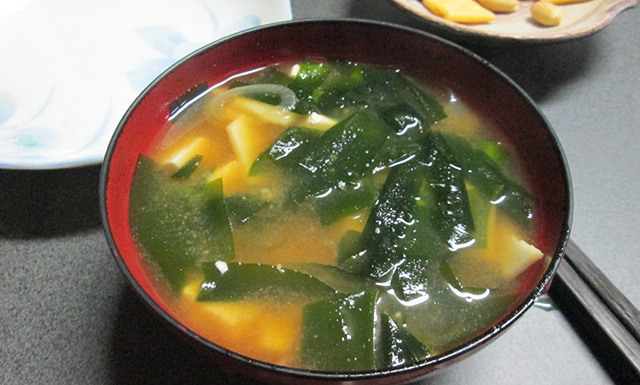 bowl of miso soup with seaweed and tofu