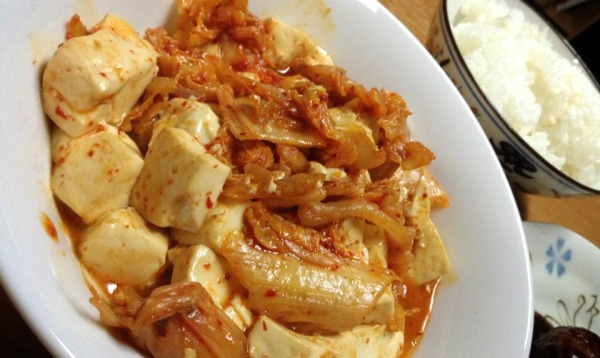 tofu fried with kimchi in white bowl