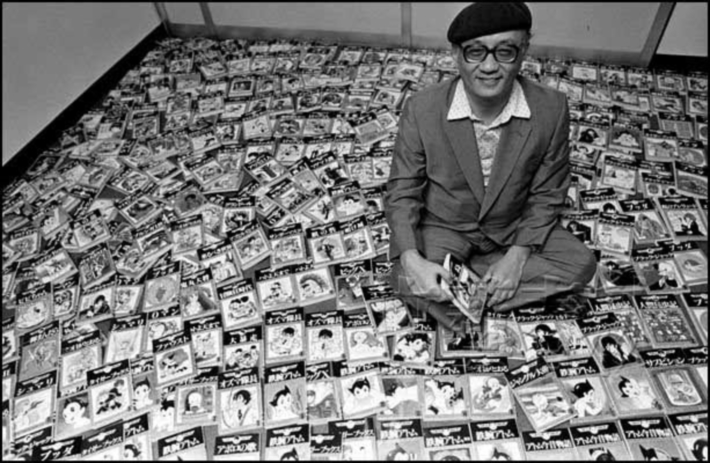 Osamu Tezuka with his artwork around him