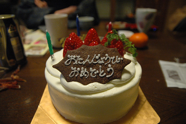 A Japanese birthday cake topped with strawberries and candles