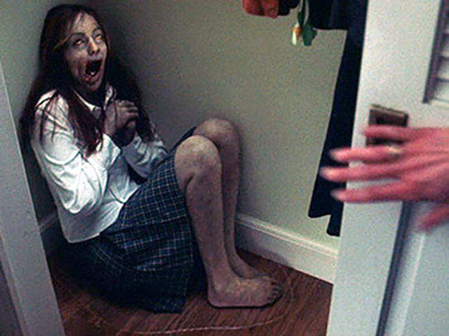 horror movie teenage girl in a corner screaming
